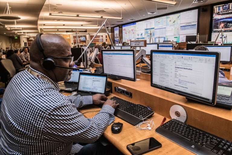 a man wearing headphones and using a computer