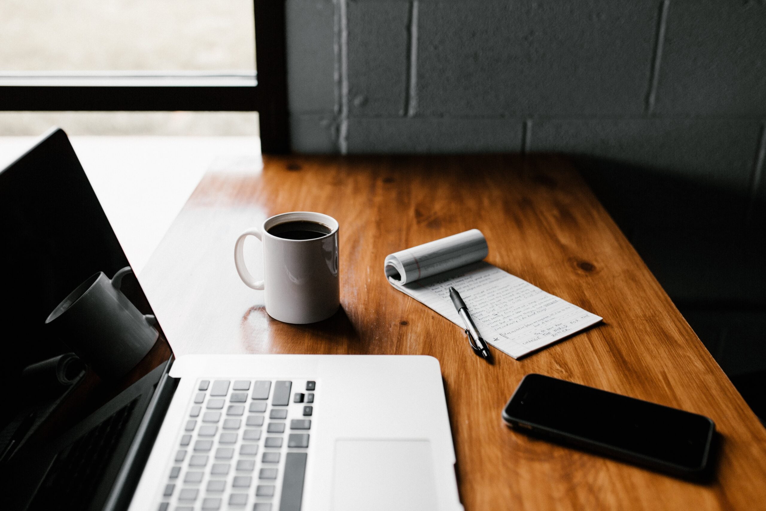a laptop and a cup of coffee on a table